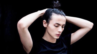 Woman messy topknot holding head - messy free wallpaper