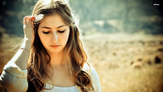 Woman field hands hair serious - a woman in a field free wallpaper