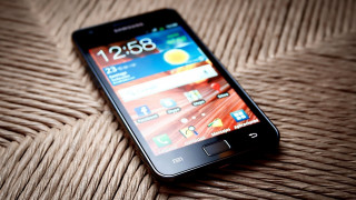 Cellphone table brown wicker photorealism - a close up of a cell phone free wallpaper for desktop