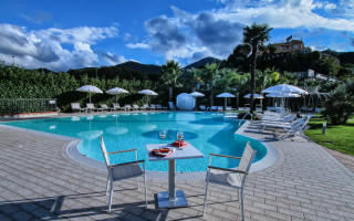 Table wine pool umbrellas chairs - a view of a mountain free wallpaper