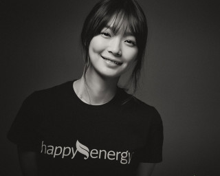 Happy woman smiling blackshirt plant - a plant in the background free wallpaper