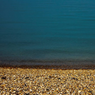 Beach person surfboard water pebbles - free beach wallpaper for tablet