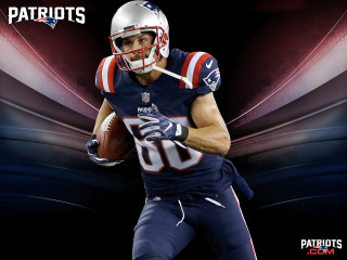 Football player holding football helmet 2 - his hand and a helmet free wallpaper