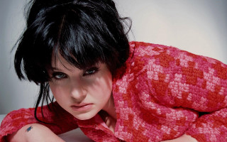 Woman blackhair redshirt bed portrait - black hair free wallpaper for desktop