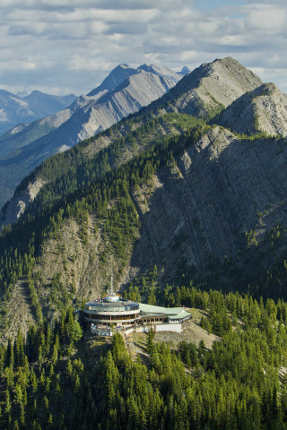 Mountain building forest sky background - free mountains wallpaper for mobile