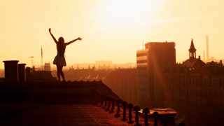 Jumping person roof sunset arms - a roof free wallpaper