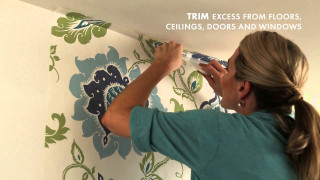 Woman painting wall flower pattern - painting free wallpaper