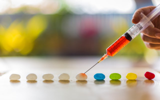 Person holding syil colored pills - dof free wallpaper