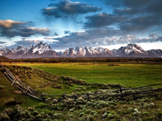 Fence field mountains clouds sky - in a field free wallpaper