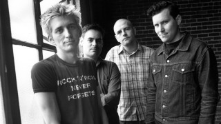 Men group standing window brick 2 - a brick wall behind them free wallpaper