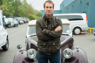 Man standing car parking lot - the background and a building in the background free wallpaper