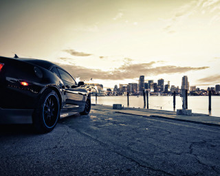 Black car road water city - the side of a road near a body of water free wallpaper