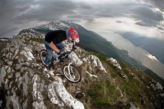 Man riding bike rocky mountain - great composition free wallpaper
