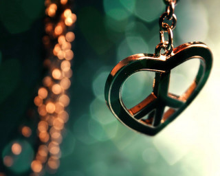 Peace sign necklace blurry background - a peace sign free wallpaper