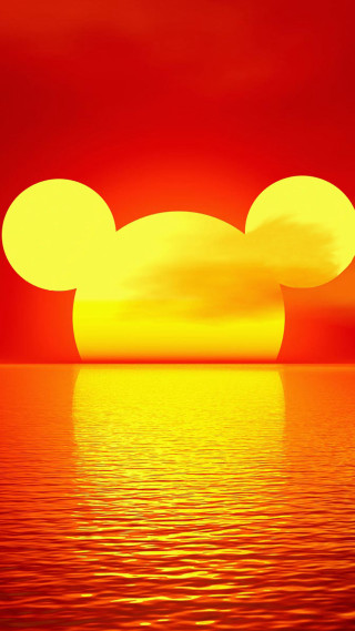 Mickey mouse silhouette sunset ocean - against a sunset over the ocean free wallpaper