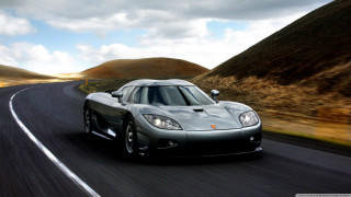 Silver sports car mountain road 2 - a mountain range in the distance free wallpaper