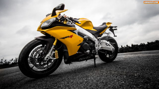 Yellow motorcycle gravel road cloudy - a yellow motorcycle free wallpaper
