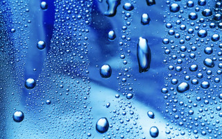 Water droplets blue surface background 4 - a close up of water droplets free wallpaper
