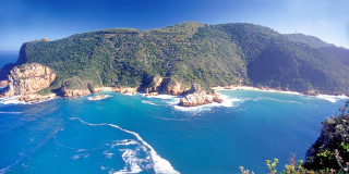 Beach mountain water foreground scenery - a mountain in the background and a body of water free wallpaper