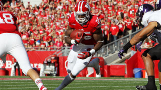 Football player running ball crowd 2 - a football player running free wallpaper