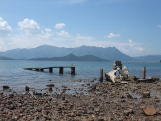 Boat water rocky shore mountains - broken free wallpaper
