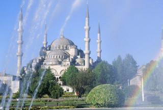 Large building fountain rainbow sky - a rainbow in the sky above free wallpaper