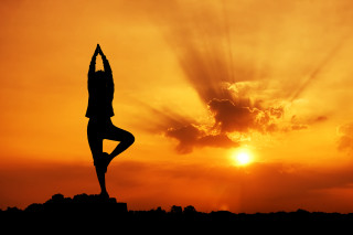 Yoga sunset person pose silhouette - the sun behind them free wallpaper