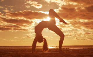 Woman handstand beach sunset sun - a handstand free wallpaper