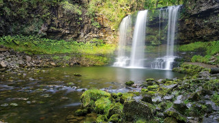Waterfall forest moss rocks sunlight - a waterfall in the middle of it free wallpaper
