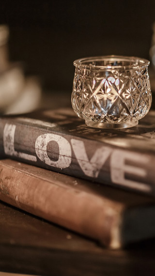 Glass candle holder book stack - a stack of books free wallpaper