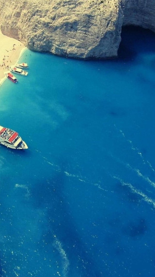 Boat water beach rock formation - free ship wallpaper for mobile