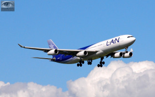 Large commercial airplane flying sky 4 - cloud below free wallpaper