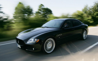 Black car driving road trees - a black car free wallpaper