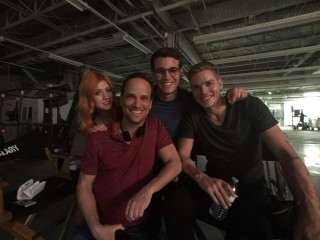 Group people sitting room ceiling - a group of people sitting next free wallpaper