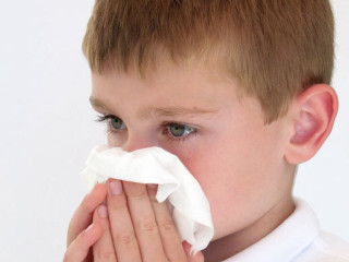 Young boy blowing nose napkin - a young boy free wallpaper