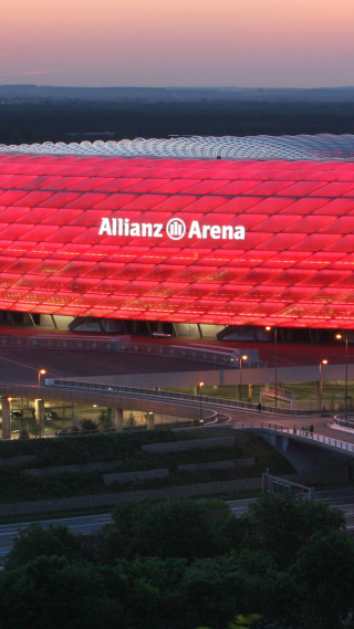 Large red building sign dusk - a sunset in the background free wallpaper for mobile