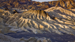 Mountain ridges desert landart cave - a sky line in the background free wallpaper