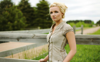 Woman standing wooden fence field - in a field of grass and trees free wallpaper