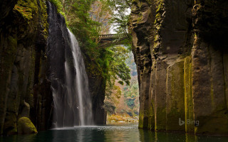 Waterfall flowing body of water - a bridge in the background free wallpaper