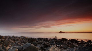 Rocky beach sunset water outcropping - a sunset in the background and a body of water free wallpaper