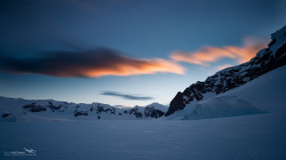 Snowy mountain cloudy sky horizon - a few snow covered mountains free wallpaper