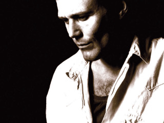 Man white shirt looking down 2 - his cell phone free wallpaper