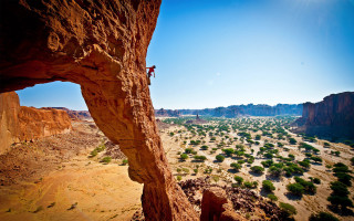 Man climbing cliff desert valley 2 - epic scale free wallpaper for desktop