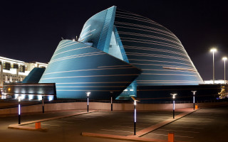 Large building curved roof nighttime 2 - modern art deco free wallpaper