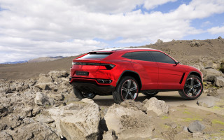 Red lamb suv rocky terrain - side profile free wallpaper