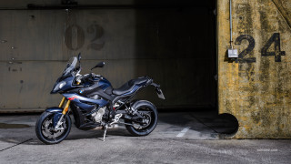 Motorcycle parked parking lot building 2 - a parking lot next free wallpaper