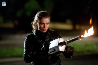 Woman holding lit object smoking - a blurry background free wallpaper