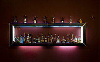 Shelf liquor bottles red wall - diffuse free wallpaper