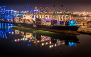 Cargo ship docked night city - dynamic free wallpaper