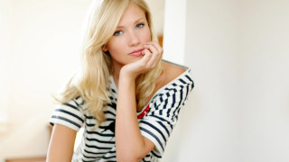 Woman leaning wall hand chin 3 - camera free wallpaper